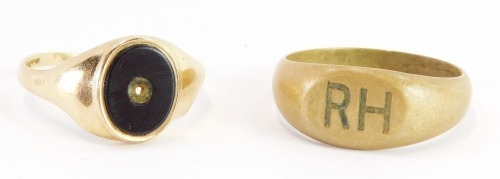 Two signet rings, a 9ct gold signet ring with oval black shield, lacking stone, 2.1g and a plated ring marked RH. (2)