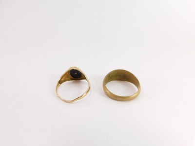 Two signet rings, a 9ct gold signet ring with oval black shield, lacking stone, 2.1g and a plated ring marked RH. (2) - 2