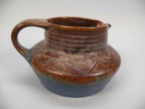 A Bourne Denby stoneware jug decorated in brown and electric blue