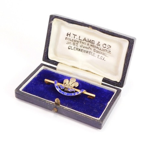 An enamel bar brooch, with central Prince of Wales feather and crown emblem bearing the inscription RMIC 1977, on a gold plated pin back in a HT Lamb Goldsmiths and Metalist box, 4.5cm wide, and the outer box inscribed RMIC Festival 1927.