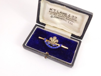 An enamel bar brooch, with central Prince of Wales feather and crown emblem bearing the inscription RMIC 1977, on a gold plated pin back in a HT Lamb Goldsmiths and Metalist box, 4.5cm wide, and the outer box inscribed RMIC Festival 1927. - 2