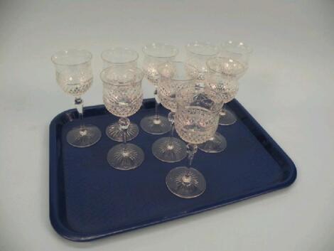 A set of nine cut glass small wine goblets