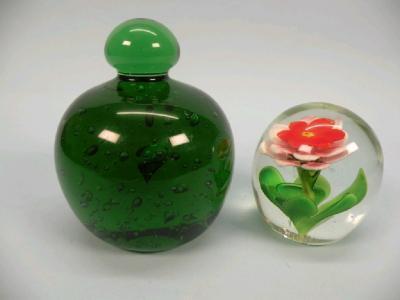 A glass paperweight in the form of a red and white flower and