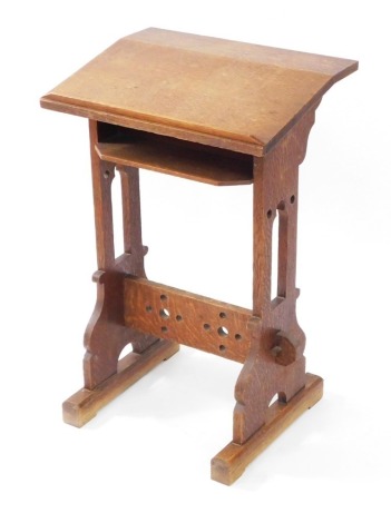 A Victorian oak lectern, with angled top, upon pierced block supports, 71.5cm high, 46cm wide, 36cm deep.