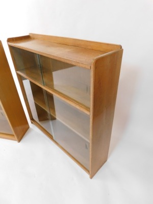 A pair of 1960's/70's light oak bookcases, each with two sliding glass doors, enclosing two shelves, each 93cm high, 92cm wide, 22cm deep. - 4