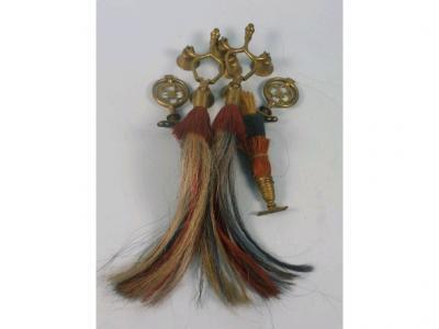 Three decorative brass and horse hair bridle attachments