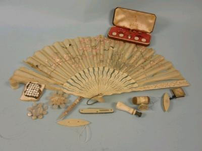 An oriental silk fan with bone sticks