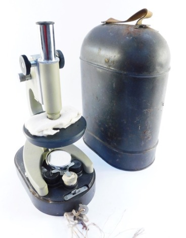 A USSR microscope, N7314167, in a tin carry case, on a grey base with accessories, 35cm high.