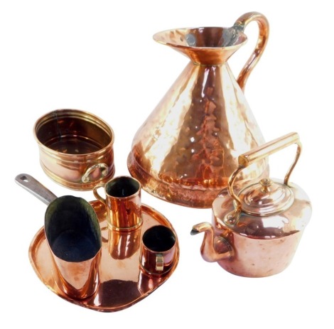 A group of early 20thC and later copperwares, to include a large copper flagon, miniature copper kettle, skillet pan lid, tankards and two bowls. (7)