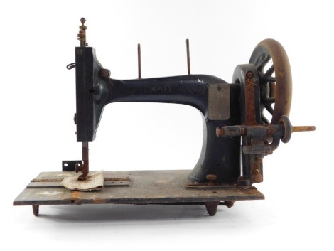 A Simplex tabletop hand sewing machine, on a black ebonised finish with mother of pearl inlay, with turned handle, 23cm high, 36cm long.