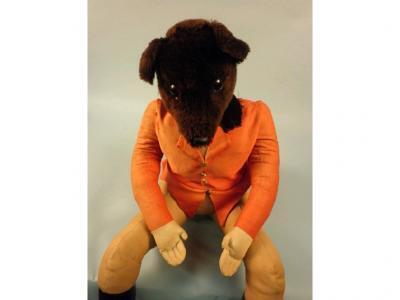 A toy fox dressed in hunting attire