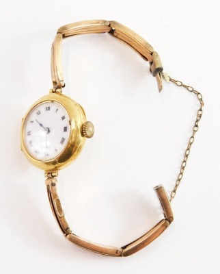 A 9ct gold cased wristwatch, with small circular wristwatch head, on white enamel back, with Roman numerals and blue hands, on a later rose gold bracelet, with safety chain, the watch head 2.5cm wide, 15.4g all in.