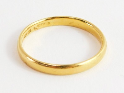 A 22ct gold thin wedding band, hallmarks rubbed, ring size O, 1.2g all in.