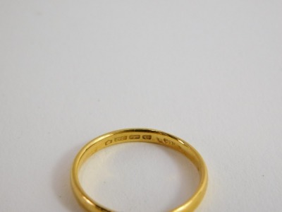 A 22ct gold thin wedding band, hallmarks rubbed, ring size O, 1.2g all in. - 2