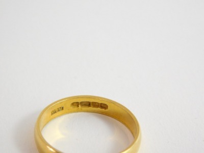 A 22ct gold thin wedding band, Birmingham 1910, ring size O½, 1.9g. - 2