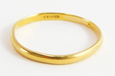 A plain wedding band, unhallmarked yellow metal, marked KBSP, ring size S, 1.4g.