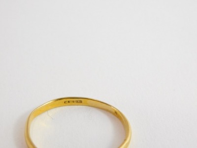 A plain wedding band, unhallmarked yellow metal, marked KBSP, ring size S, 1.4g. - 2