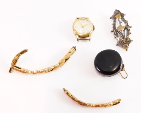 A small group of jewellery, comprising an Iris gold plated watch head, a two part 9ct gold watch chain (AF), 2.8g, a jet brooch/earring, and a silver bar brooch. (4)