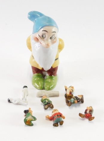 A Walt Disney 1930's porcelain Bashful dwarf toothbrush holder, together with five cold painted miniature dwarf figures, and three Victorian and later bisque miniature dolls. (a quantity)