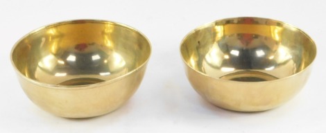 A pair of bronze bowls, polished, unmarked, 11cm wide.