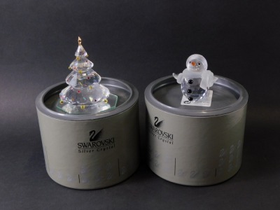 Two Swarovski crystal Christmas ornaments, comprising a snowman and Christmas tree, boxed. (2) - 2