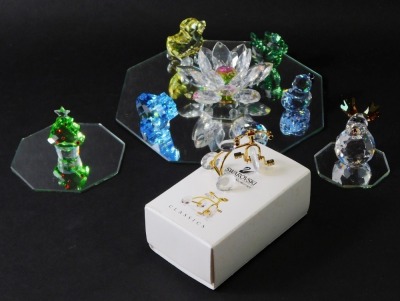 A group of Swarovski crystal ornaments, comprising Crystal Memories classics bicycle, duck on wheels, flower, Christmas tree, reindeer, blue horse, dragon, duck, 2003 Swarovski crystal and three mirrored stands. (a quantity)