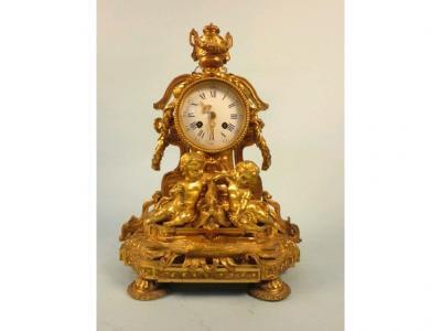 A mid to late 19thC French gilt metal mantel clock with enamel dial