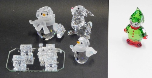 Five Swarovski crystal ornaments, comprising the Disney rabbit, Santa's Helper, snowman in scarf with briefcase, snowman and a train set, all boxed. (5)