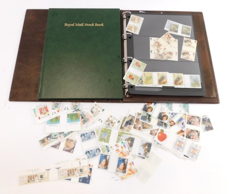 Philately. A Royal Mail stamp album containing unused UK stamps, boating and lighthouse scenes, religious scenes, college building press, bulls, etc., together with an empty green album. (a quantity)