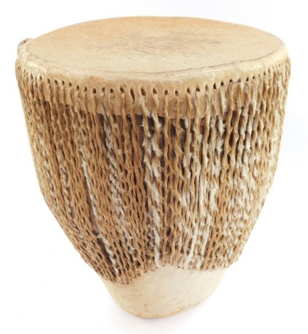 An African hide bound tribal drum, 34cm high.