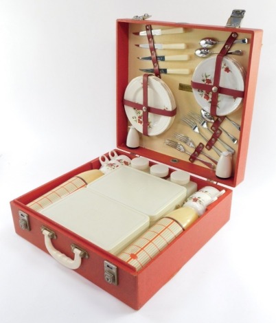 A Brexton picnic hamper, four place settings, with cups, plates, cutlery, storage containers and vacuum flasks.