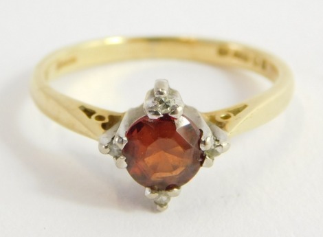 An 18ct gold and orange coloured gem set ring, with diamonds at points, size J/K, 2.7g.