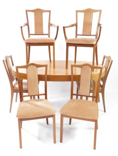 A Nathan teak extending dining table and six teak dining chairs, the oval top on stylised legs, the seat with pink upholstered cushions, 76cm high, 153cm wide, 99cm deep.