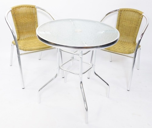 A chrome and glass garden bistro table, with a mottled glass top, with circular centre section on a chrome base, with two cane weaved chairs, 72cm high, 71cm diameter. (3)