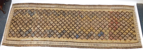 A Caucasian brown ground runner, decorated with vary coloured tree motifs, within geometric borders, 265cm x 97cm.