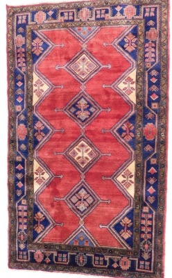 A Persian Koliai - Kurdi carpet, red ground decorated with four central guls, flanked by half guls within geometric and floral borders, 248cm x 150cm. (with certificate)