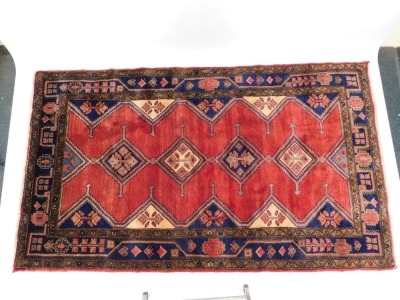 A Persian Koliai - Kurdi carpet, red ground decorated with four central guls, flanked by half guls within geometric and floral borders, 248cm x 150cm. (with certificate) - 2