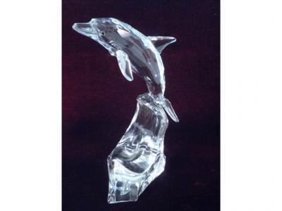 A Swarovski Silver Crystal dolphin on a stylized wave complete with fitted case