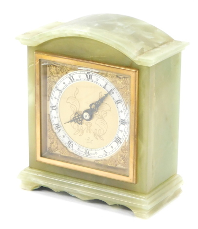 An Elliott green onyx mantel clock, engraved square brass dial with cherub spandrels, silvered chapter ring bearing Roman numerals clockwork movement, the case of architectural form, 16cm high.