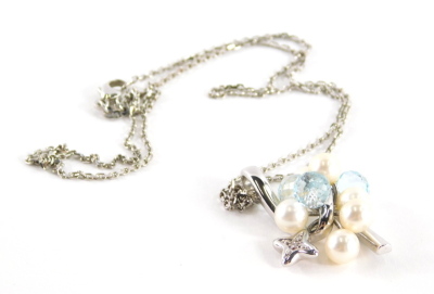 An 18ct white gold pearl diamond and blue topaz pendant and chain, the cluster design with three pale blue topaz faceted beads, six 5.5mm diameter Akoya cultured pearls, and a star shape drop centre by a diamond point, white metal mount and chain, total e - 3