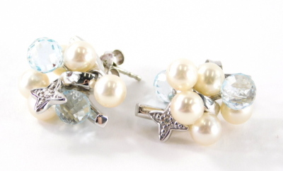 A pair of 18ct white gold pearl diamond and blue topaz earrings, each of cluster designs set with two blue topaz and five pearls with a diamond set star drop, on single pin back with butterfly backs, 2.2cm high, 10.9g all in. - 2