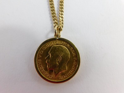 A George V full gold sovereign pendant and chain, dated 1912, on curb link chain marked 9ct, 60cm long, 22.1g all in. - 7