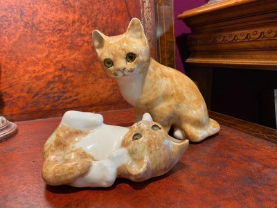 Two late 20th century hand painted pottery playful cats, each signed by Jenny Winstanley, sizes 2 and 3, selected by TV celebrity Susan Calman. NB. This is a charity lot and there is no Buyers Premium payable. Collection is from The Lincoln Auction Rooms