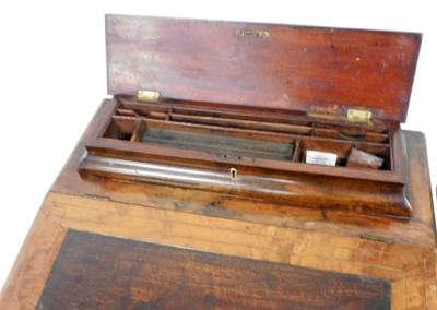 A Victorian walnut and marquetry inlaid Davenport, the hinged lid enclosing a fitted interior for pens, cards, etc., above a fall with a later hardwood inset panel enclosing a fitted interior above side drawers with turned wood handles, on a shaped platfo - 3