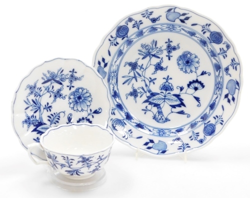 A Meissen Onion pattern trio, comprising a blue and white cup and saucer, each with floral scrolled patterning and blue cross sword mark to underside, together with a matching plate. (3)