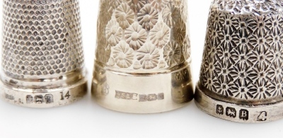 A group of twelve silver thimbles, each of varying design, some in thimble cases, 3½oz. - 3