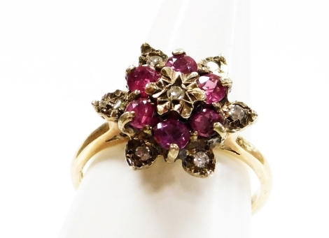 A 9ct gold dress ring, with central garnet and cz cluster, on a raised basket setting, ring size L½, 3.3g all in.