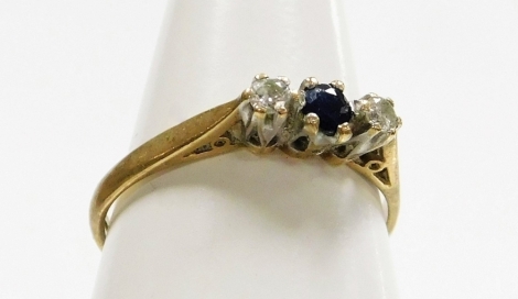 A 9ct gold three stone dress ring, set with tiny sapphire and two diamonds, each in claw setting, ring size L½, 1.4g all in.