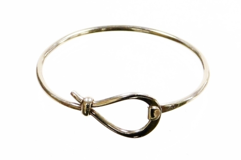 A hoop and loop bracelet, white metal, marked 925, 6cm wide.