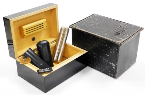 A polished humidor, of rectangular form and tin of cigar related items, leatherette case, cigar cutters, etc., the humidor 28cm wide, and a further metal tin of rectangular form. (AF, 2)